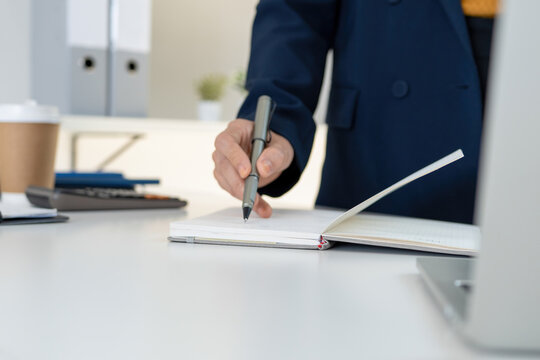 Close Up of Businesswoman Hands Using Calculator and Analyzing Charts at Office Desk
