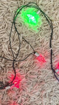 Flashing christmas star shaped string lights illuminating a cozy beige carpet with a festive holiday glow, creating a warm and vibrant atmosphere for the celebration