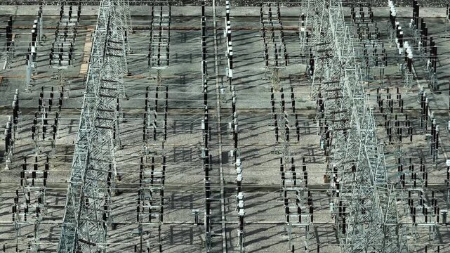 High angle view of a power substation filled with transformers and transmission structures, symbolizing technological innovation, energy security, and efficient electricity distribution networks. 4k.
