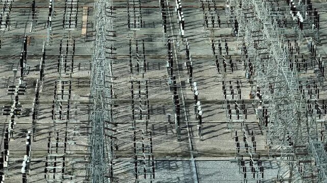 A high voltage substation showcasing complex power grid infrastructure, precision engineering, and advanced energy distribution systems supporting grid stability and reliable electricity networks. 4k.