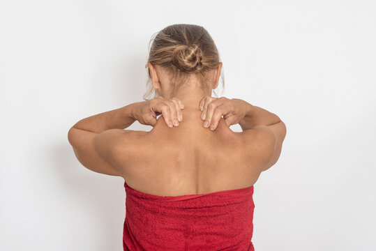 Self massage of neck and shoulder muscles, neck pain and headache. Woman with bare shoulders on white.