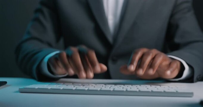 Hands typing on white wireless keyboard at office setting