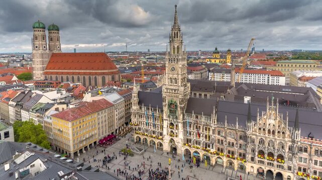 Timelapse of the Munich skyline featuring the iconic New Town Hall, Marienplatz and the historic city center beneath dramatic storm clouds in Bavaria, Germany.