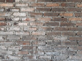 Fototapeta premium old brick wall texture background with weathered cement mortar