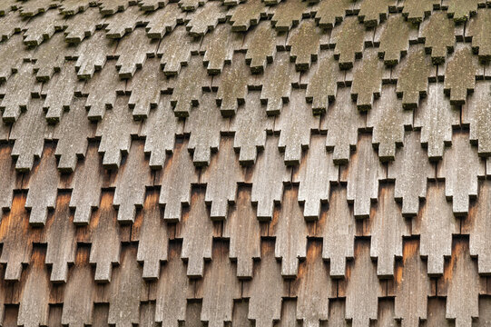 Wooden shingle roof texture of traditional russian wooden church. Close up of layered wooden shingles called lemech covering the roof of a traditional Russian Orthodox church