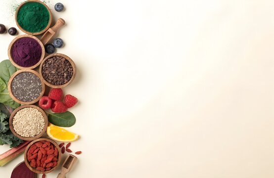 Flat lay of natural food ingredients with powders, seeds, fruits, and greens on beige background, vibrant composition promoting nutrition and holistic wellness lifestyle generated ai