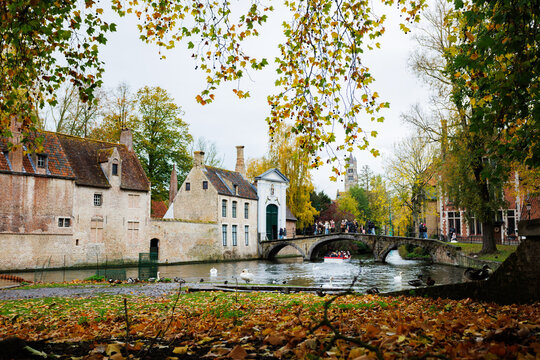 Autumn canal view in Bruges with a Begijnhof bridge, Belgium
