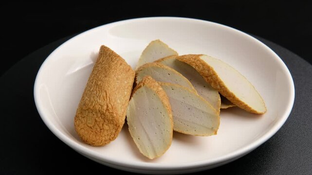 Golden stick fishcake or fried fish bar in white plate.In Thai cuisine, it is commonly added to noodle dishes.