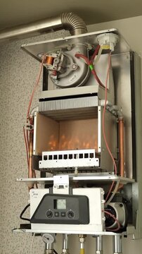 Open gas boiler during maintenance and cleaning in residential apartment heating system. 