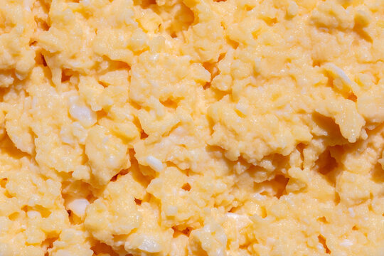 Organic scrambled egg, made with chicken eggs, butter and milk, background backdrop. Healthy breakfast food concept.