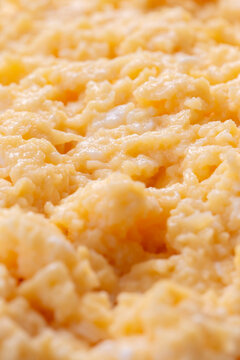 Organic scrambled egg, made with chicken eggs, butter and milk, background backdrop. Healthy breakfast food concept.
