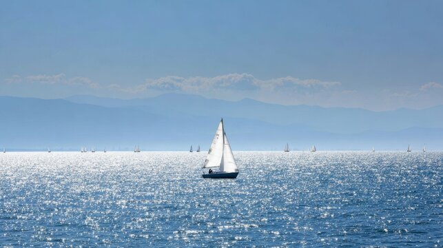 Sailboat on sparkling water celebrating sailing, adventure, and calm. Mountains and sky completing a scenic seascape
