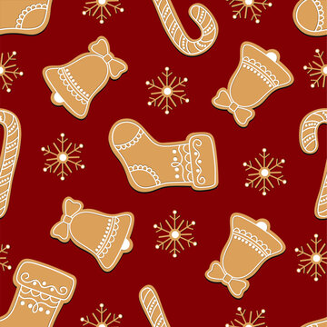 Festive gingerbread Christmas seamless pattern with decorated bells, candy canes and snowflake motifs on a rich red background.