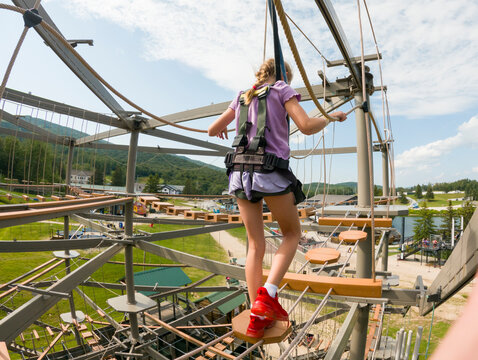 Active Lifestyle girl climb balance  obstacle course outdoors 