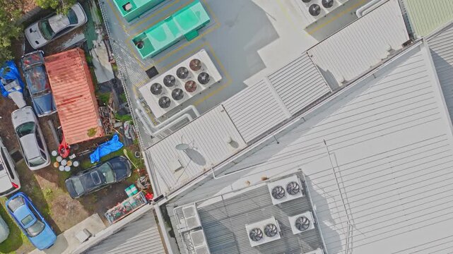 Aerial top view of commercial building rooftop with hvac units
