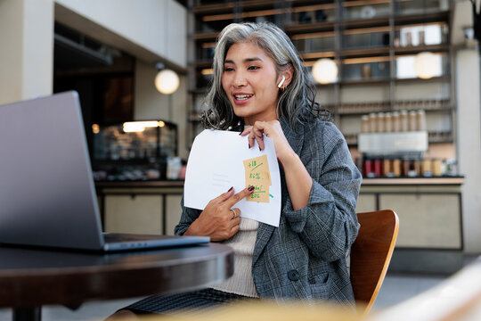 Woman presents business data on video call.