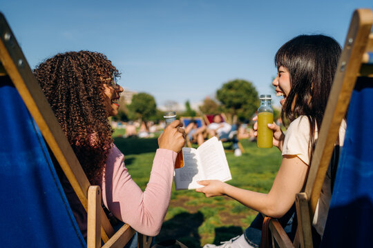 Two women talking while sitting outdoors