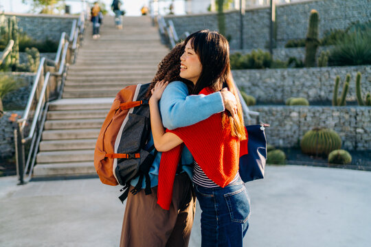 Two women hug at a meeting