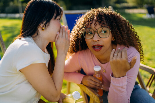 Two women talking while sitting outdoors