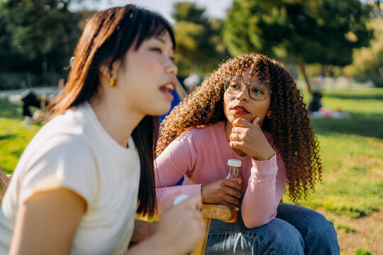Two women talking while sitting outdoors