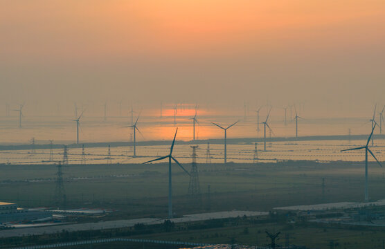  floating solar farm and wind turbines at sunset over water