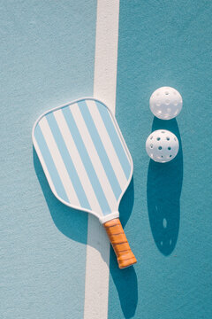 Pickleball Paddle and Balls on Court