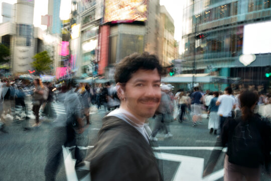 Man Smiling Still at Busy Shibuya Crossing