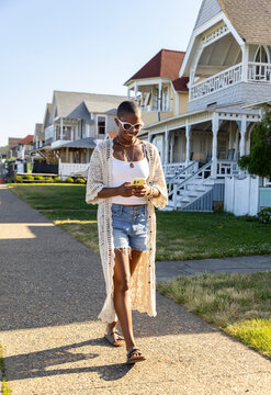 Black woman walk  Cell phone outdoors 