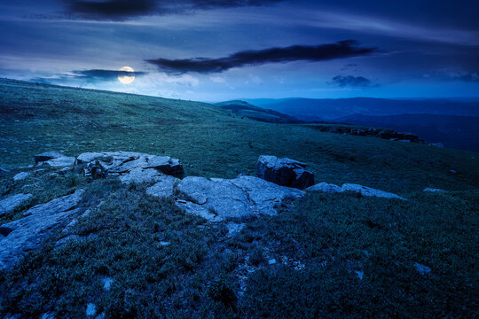 carpathian mountain landscape on summer night. mysterious background for outdoor adventure in the dark. transcarpathia green hill with rocks in foll moon light