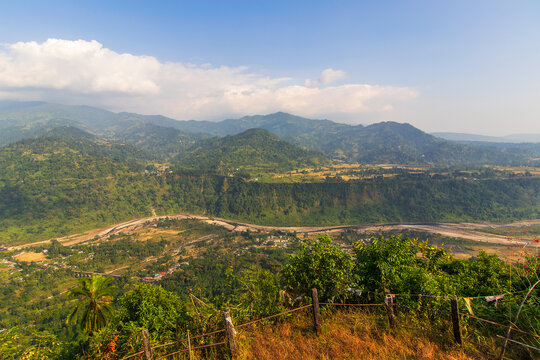 View of India Bhutan border, Bhutan mountains of Himalayas , green forests and Jaldhaka river flowing between Bhutan and India, view from Dolgaon view point at Jhalong , Dooars - West Bengal , India.