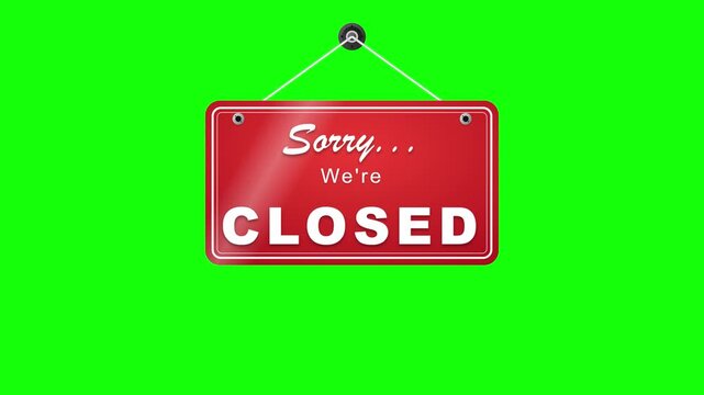 Red "sorry we're closed" hanging sign on green screen for easy chroma key compositing