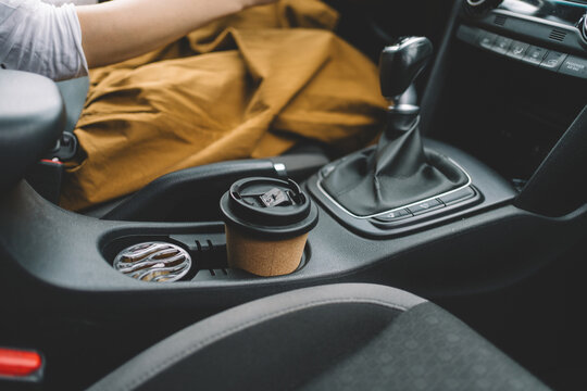 Coffee cup in vehicle cup holder during commute