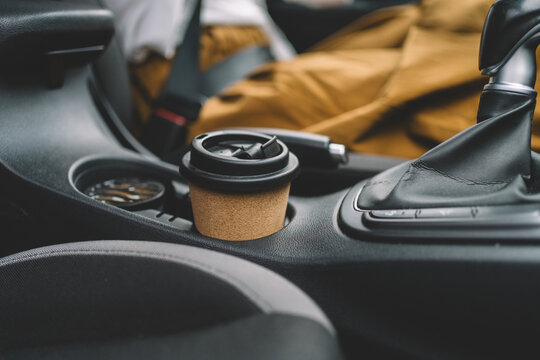 Takeaway coffee in car cup holder