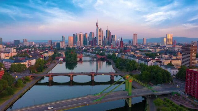 Aerial view of the Frankfurt skyline featuring the modern financial district, iconic skyscrapers and the Main River at sunset in Germany.