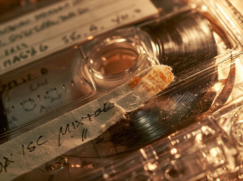 Vintage cassette tape on music collection shelf with handwritten label, analog recording and retro 90s audio playback