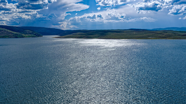Panorama of the glint of sunlight shining over the waters of the Strawberry Reservoir east of Heber City, Utah, USA
