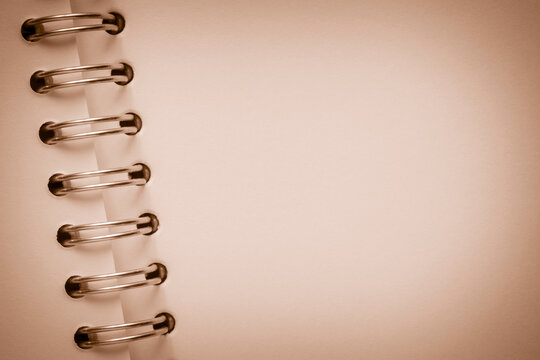 close up of blank page of notepad with metallic spiral binder