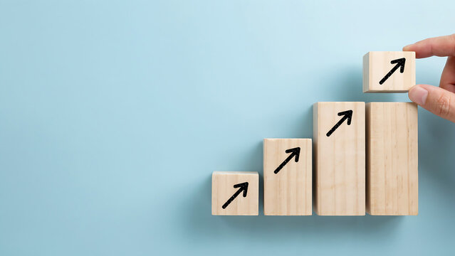 Hand placing wooden block with upward arrow on growth chart success progress