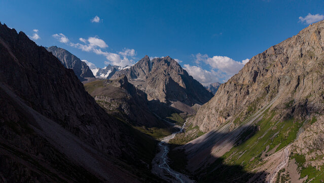 Wide landscape view of Ala-Archa gorge and Nomads Peak in Central Asia.