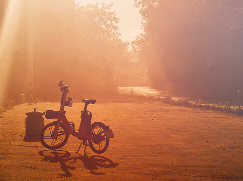 Outline shadow of the electric bike during dramatic sunset transport