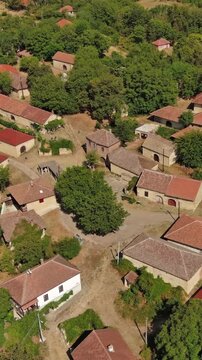 Aerial around view of old rustic vintage houses with wine cellars in Rogljevacke pivnice in Negotin region of Serbia. Vertical video 4k