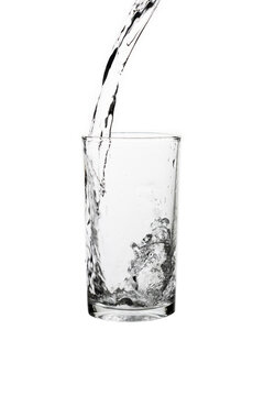 Pouring fresh drinking water into a clear glass isolated on a white background. Hydration, purity, refreshment, and healthy lifestyle concept.