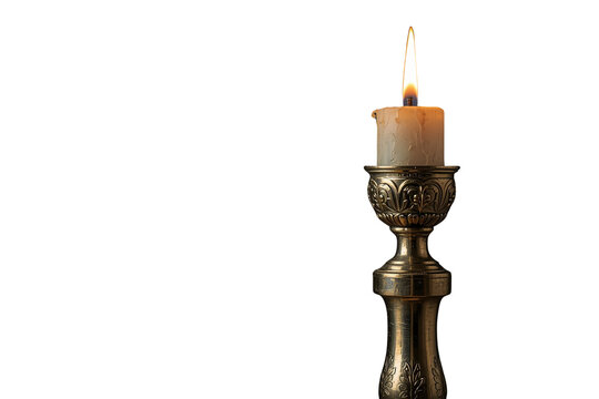 Burning candle in vintage engraved candlestick