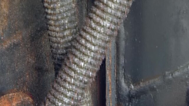 A detailed look at the sturdy, yet neglected, air filter mounting structure. Rust blossoms on metal surfaces and thick grime clings to bolts and insulated wires, telling tales of hard work.
