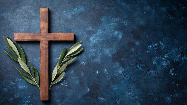 Wooden christian cross with olive branches on blue background symbolizing faith hope and spirituality
