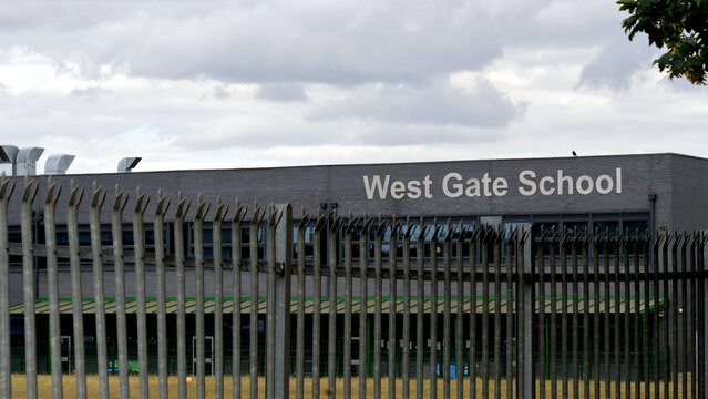 Leicester, England, UK - 26 July 2026: West Gate School building in Leicester behind security fence under overcast sky