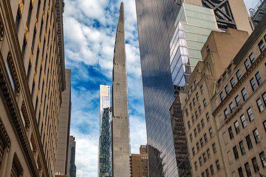 Impressive view of tall luxury residential towers along Billionaires Row captured from a Midtown Manhattan street, showing impressive urban architecture and soaring skyscrapers in New York.