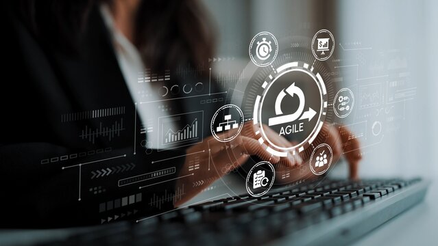 Agile Project Management Concept with Visual Icons and Metrics Displayed on a Digital Screen While a Professional Uses a Keyboard. Entropy.