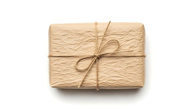 Small rectangular parcel wrapped in wrinkled brown paper tied with a simple rustic twine string