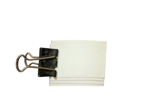 Small white note paper attached with a black binder clip